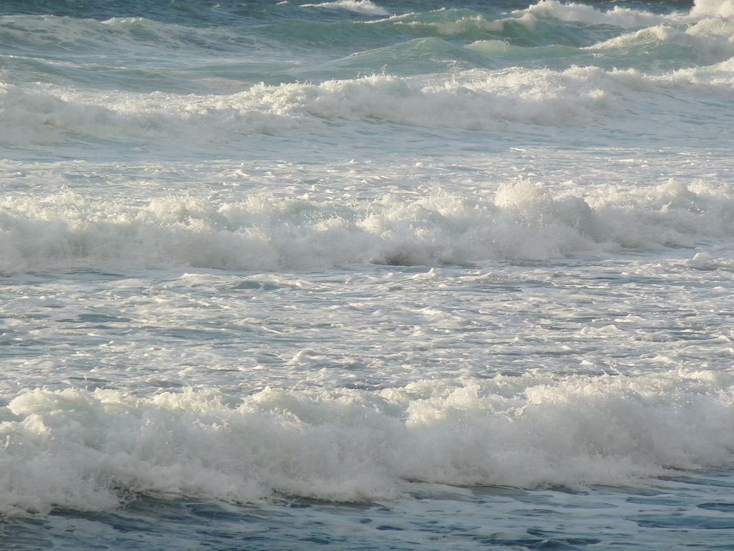 rough seas on crete with rolling white waves