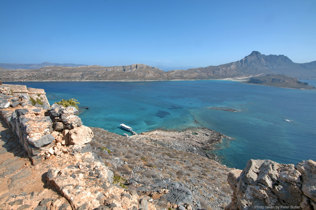 The view from the castle at Gramvousa island and the boat moored below for the Gramvousa Boat Trip