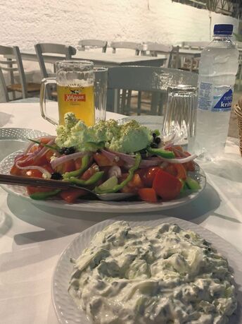 Greek salad tzatziki and Harma beer taverna table on crete